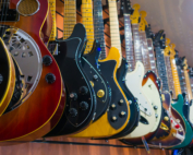 Different electric guitars hang in the music instruments store