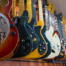 Different electric guitars hang in the music instruments store